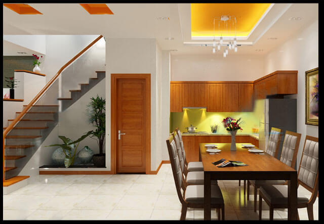 Phần giếng nhà hai tầng, trời giữa nhà ở tầng một có mảng cây xanh cùng hồ cá bên cạnh hành lang liên kết phòng khách và phòng ăn, bếp. Một chiếc ghế tựa đơn giản là nơi chủ nhà có thể tận hưởng cảm giác thảnh thơi, bình yên.