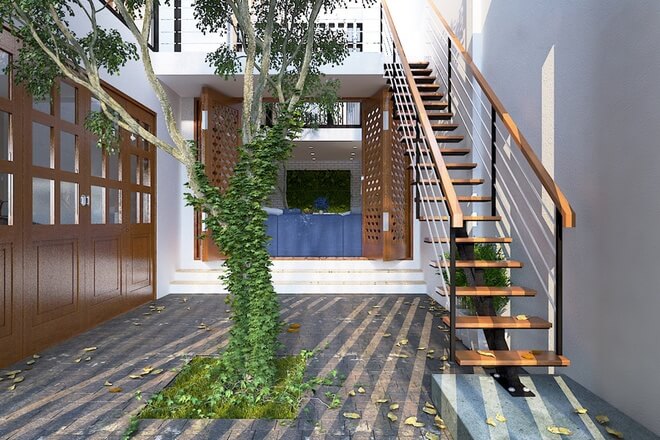 cây xanh bố trí đặt ngay cầu thang chính dẫn lên tầng 2 trong ngôi nhà ở với nhiều không gian xanh