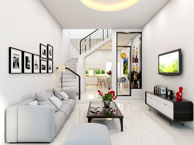 Thiết kế nhà ống, Phòng khách với tông màu trắng sáng sủa. Dàn kệ gỗ màu đen và những bức tranh đen trắng tạo điểm nhấn cho không gian thêm đẹp mắt