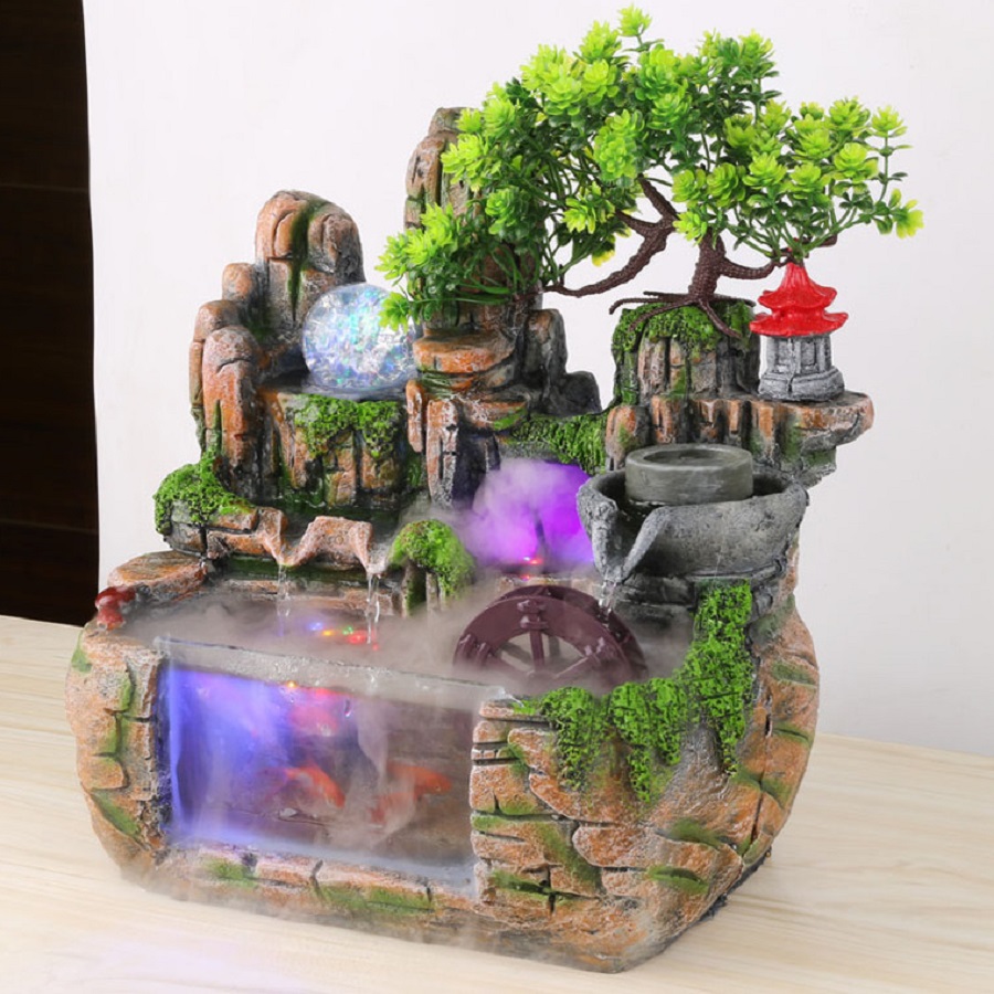 Hòn non bộ mini là sự kết hợp giữa tiểu cảnh, quả cầu thủy tinh, hồ cá và thác nước.