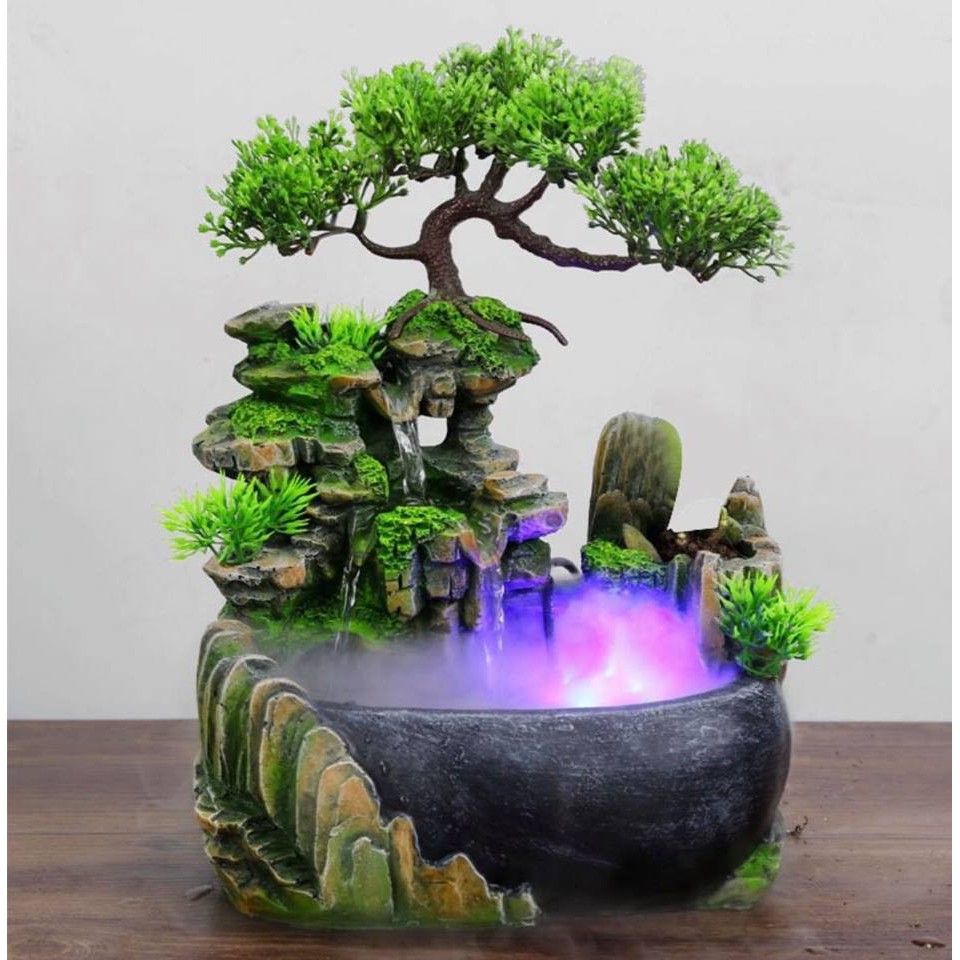 Hòn non bộ mini với tiểu canh núi, cây và thác nước.